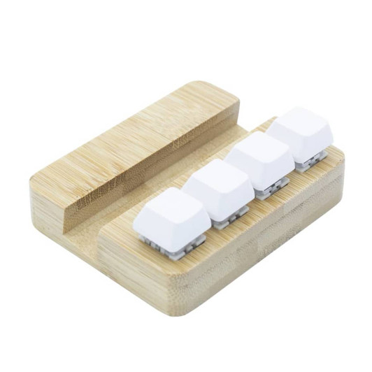 A bamboo stand holder featuring four white key pressing stress relievers. It has a smooth, natural finish.