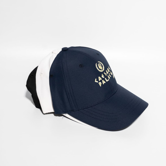 A navy blue and white baseball cap with a Velcro strap, featuring a logo on the front.
