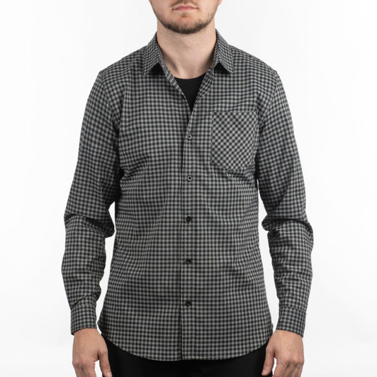 A black and white checkered patterned shirt with a single pocket and long sleeves. It features a logo.