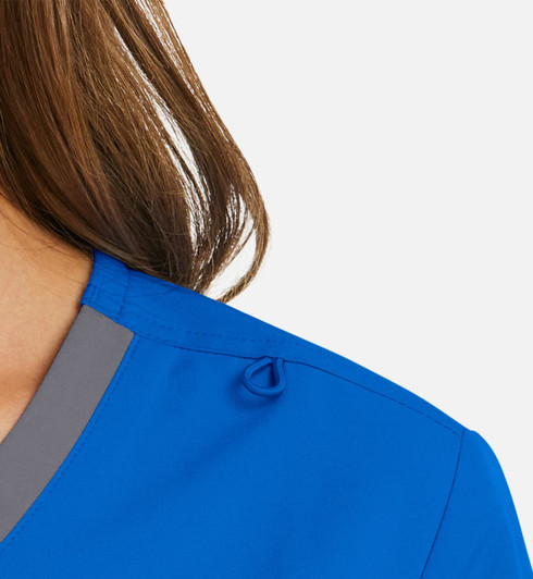 A vibrant blue mock wrap top featuring a contrast grey trim and a decorative detail on the shoulder.