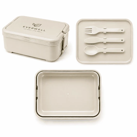A beige lunchbox with a lid, accompanied by a matching plate and utensil set, featuring a logo on the lid.