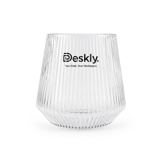 A clear glass tumbler with ribbed texture and a logo at the front.