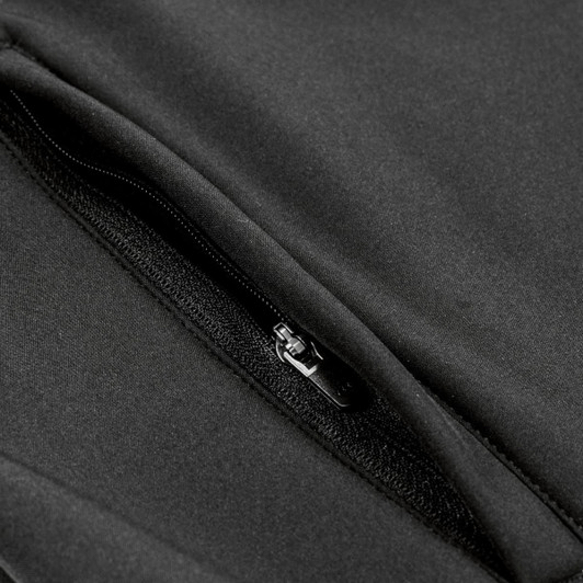 A close-up of a black softshell jacket featuring a zippered pocket and sleek fabric texture.