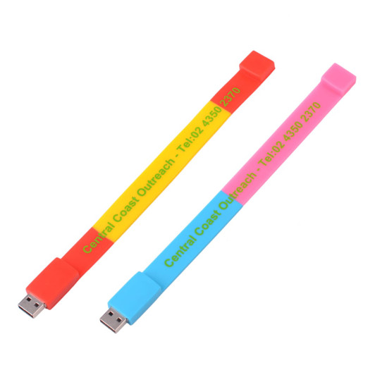 A colourful sectional wristband flash drive in red, yellow, pink, and blue, featuring a logo.