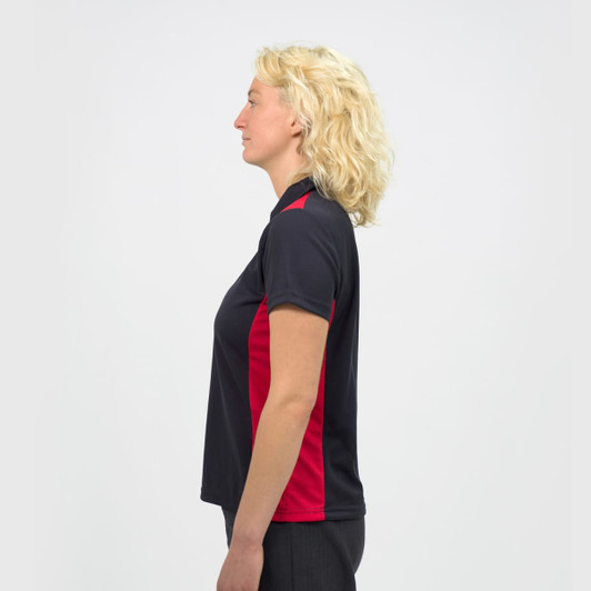 A women's polo shirt in black with red accents, featuring a collar and a side view of the model.