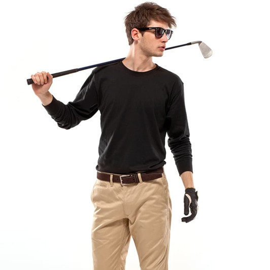 A model wearing a black long-sleeve top, beige trousers, sunglasses, and golf gloves, posing with a golf club.