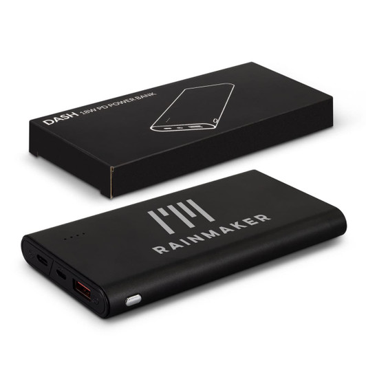 A black power bank with a logo, placed next to its packaging. It features multiple USB ports.
