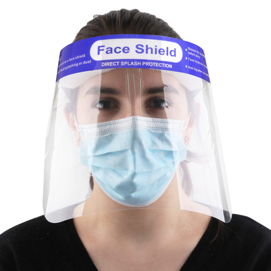 A protective face shield made of clear plastic, worn over a blue surgical mask, features a logo on the top.