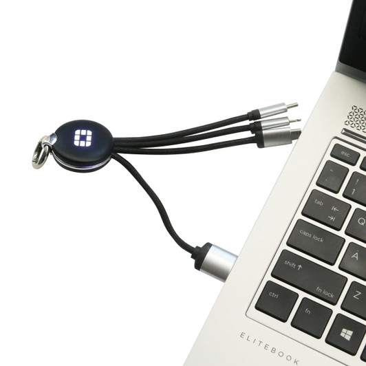 A round-shaped light-up charging cable in black with multiple connectors, plugged into a laptop's USB port.