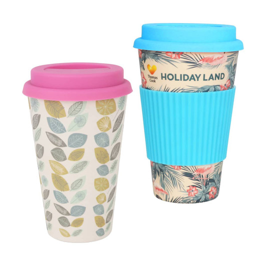 A reusable bamboo coffee cup set in pastel pink and blue, featuring leaf patterns and a textured grip.