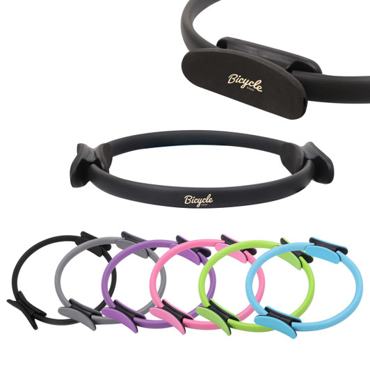 A Pilates circle in various colours including black, grey, pink, purple, and green, featuring a logo.