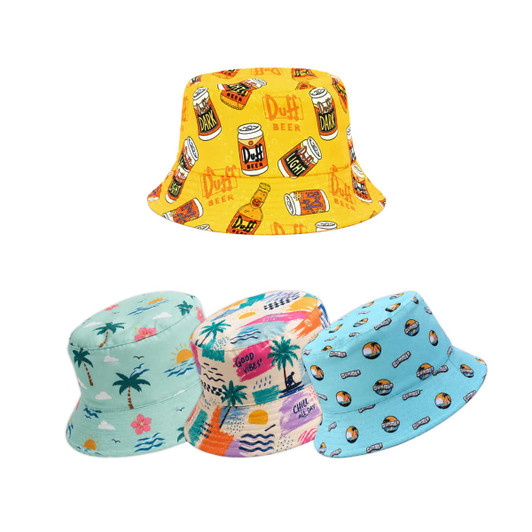 A brightly patterned bucket hat in yellow with a beer motif, alongside three colourful hats in various designs and shades.