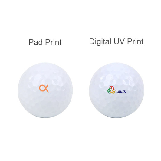 A set of two white golf balls, one featuring a pad print logo and the other with a digital UV print logo.