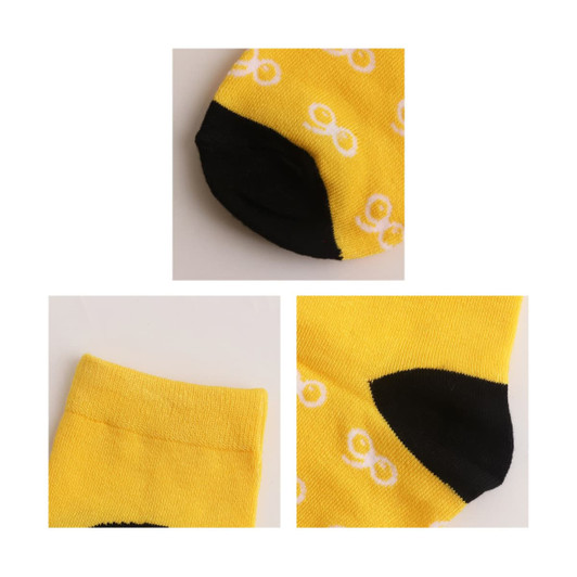 Yellow woven bamboo socks featuring a black heel and toe, with a repeating white pattern, alongside a logo.