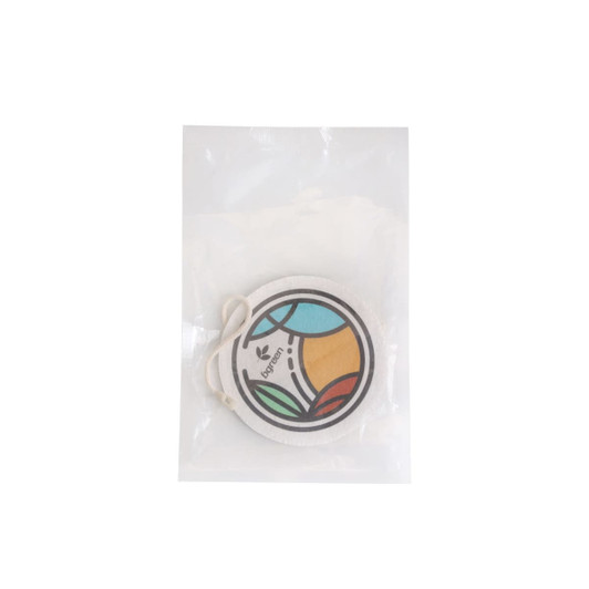 An expandable dishwashing sponge in a clear package, featuring a colourful circular design with green, blue, and orange elements.