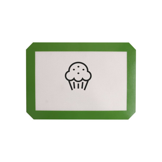 A silicone baking mat with a white surface and a green border featuring a cupcake design in the centre.