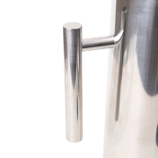 A stainless steel pitcher with a sleek, polished finish and a cylindrical shape, featuring a simple handle.