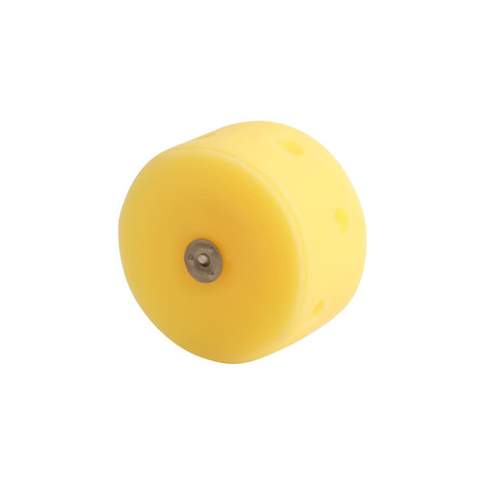 A round yellow candle shaped like cheese, featuring a metal base and several holes.