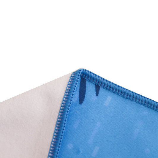 A microfibre beach towel in blue and white, featuring a stitched edge and a patterned design.