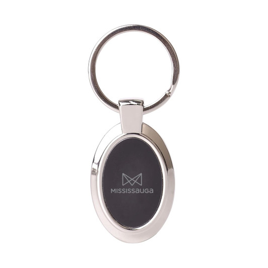 A silver oval keyring featuring a black insert and a logo on one side.