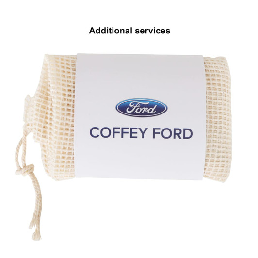 A cream-coloured organic cotton mesh bag tied at the top, featuring a logo on a label.