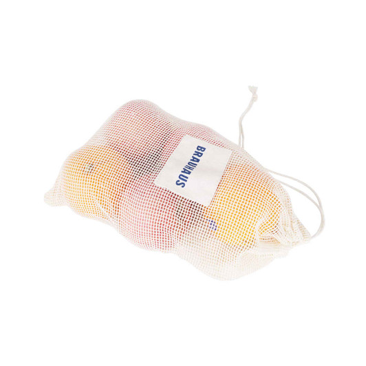 A white organic cotton mesh bag containing oranges and apples, secured with a drawstring closure.