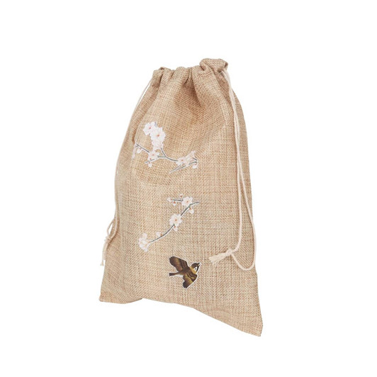 A large jute produce bag in natural beige, featuring floral and bird illustrations, and a drawstring closure.