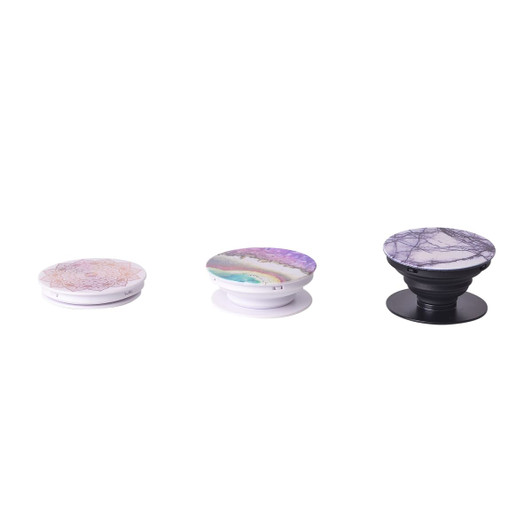 Three phone pop holders in various designs, featuring pastel colours and intricate patterns. Each holder has a different base colour.
