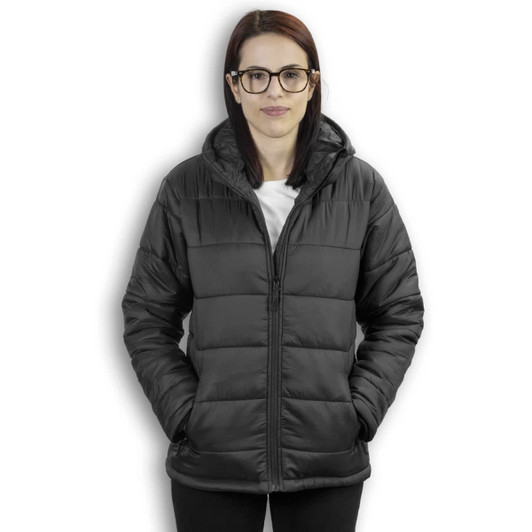 A woman wearing a black puffer jacket with a hood, featuring zippered pockets. The jacket has a logo on it.
