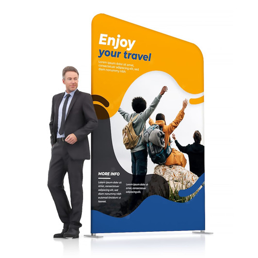 Inclined portable exhibit display wall in blue and orange, featuring a promotional travel design and a logo, with a person beside it.