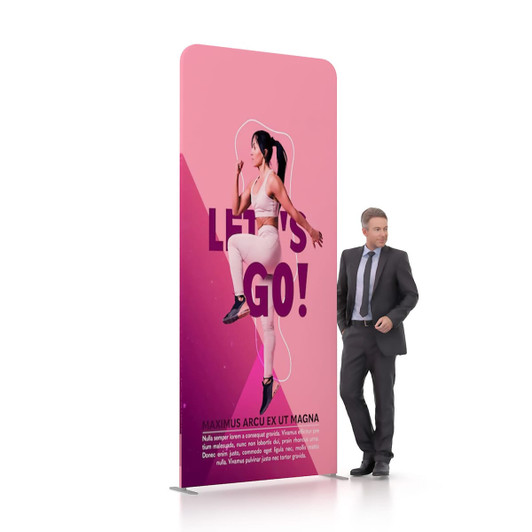 A pink tension fabric display wall featuring a figure in a dynamic pose, with a man in a suit standing beside it.