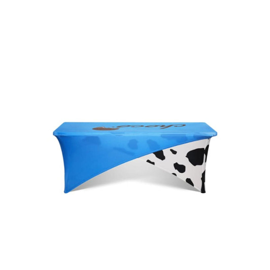 A blue and black cow-print stretch tablecloth designed for a 4ft table. It features a logo.