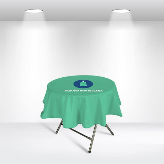 A round table cover in light green with a logo, featuring a message about hand washing.