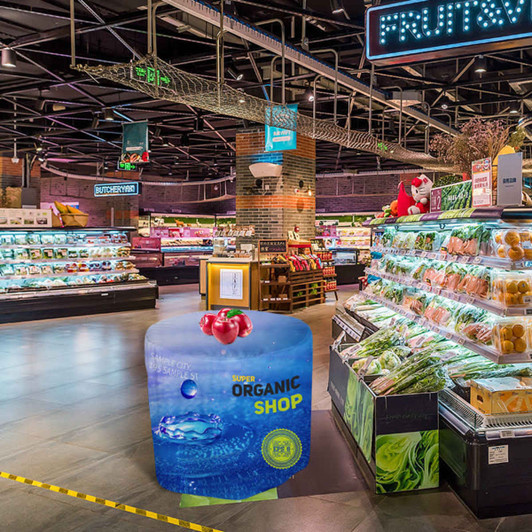 A round fitted table cover featuring vibrant blue and green colours, with a logo and tomatoes on a shopping aisle backdrop.