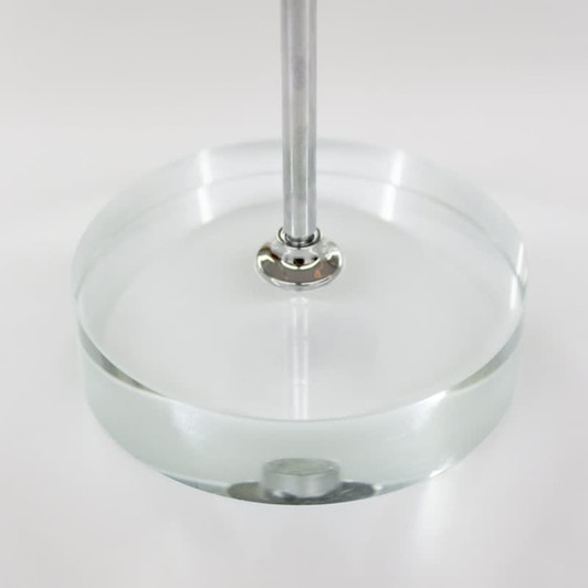 A clear circular base with a metal rod, designed for displaying desk flags.