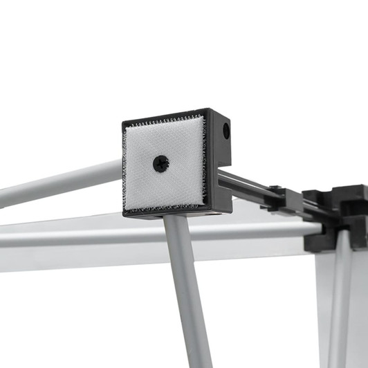 A close-up of a fabric popup display frame, featuring grey metal components and a textured connector.