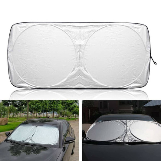 A foldable car shade in silver, featuring a circular design, displayed on a car windshield. It has a logo.
