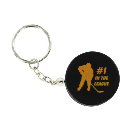 A black hockey puck stress reliever attached to a keyring, featuring a silhouette of a hockey player and text.