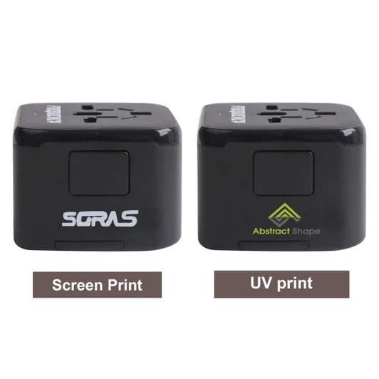 A universal travel adapter with USB-C ports in black, featuring two different print designs and a logo on each side.
