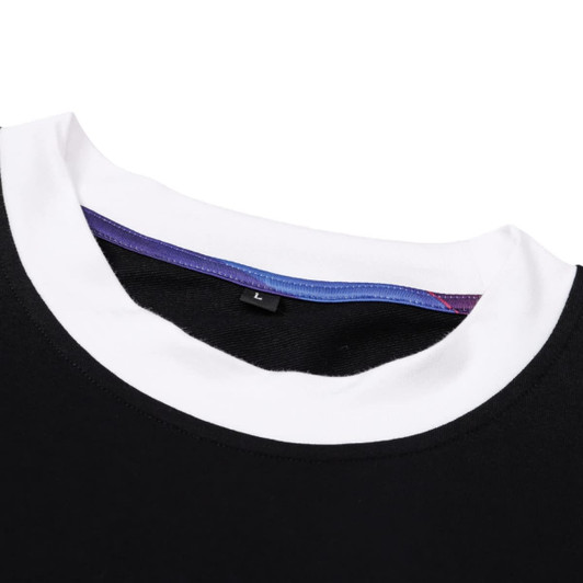 A black T-shirt featuring a white collar and a colourful inner neckline, with a small label visible.