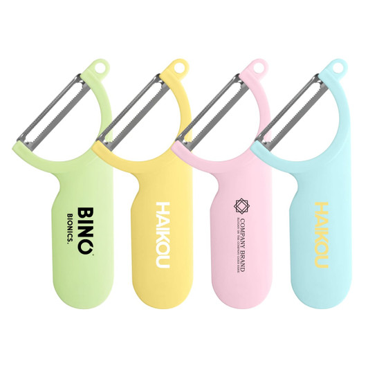 A set of four peelers in green, yellow, pink, and blue, each with a logo on the handle.