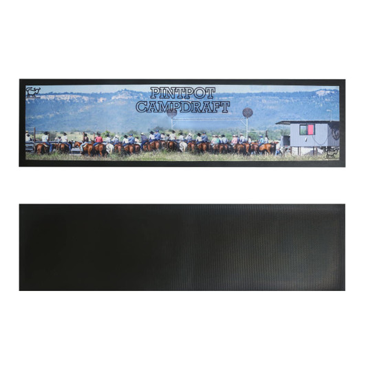 A long counter mat featuring a vibrant outdoor scene with horses and riders, predominantly in green and brown tones.