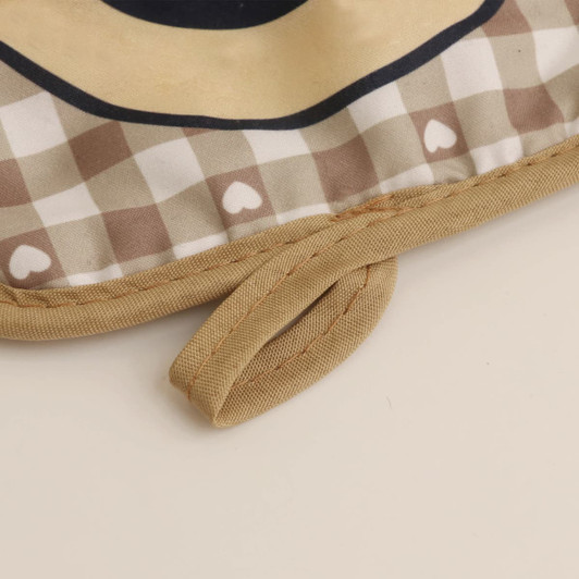 A medium quilted pot holder featuring a checkered pattern in beige and brown, with a fabric loop for hanging.