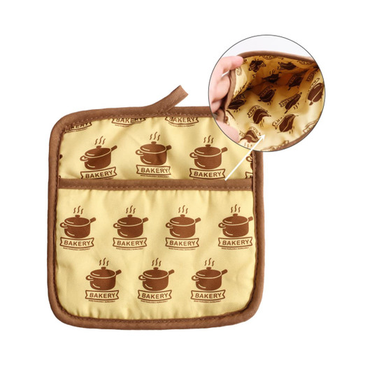 A large quilted pot holder in yellow with brown bakery-themed print and a brown trim, featuring a patterned interior.