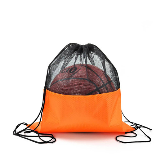 An orange drawstring mesh backpack with a black top, holding a basketball inside. It features a logo.