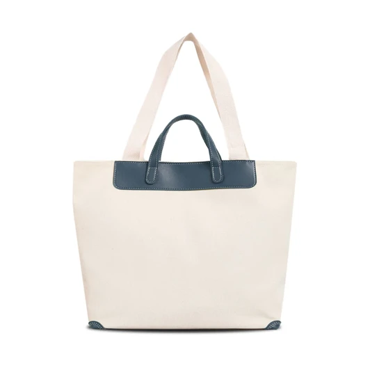 A cream canvas bag featuring a navy leather handle and straps, with a simple design and a logo present.