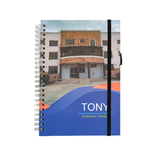 A5 wiro-bound notebook featuring a colourful design with a black elastic band closure.