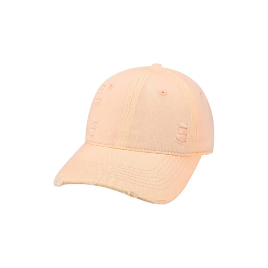 A vintage baseball cap in a soft peach colour, featuring distressed detailing and a curved brim.