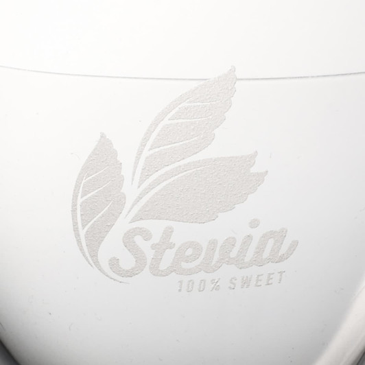 A white container with a textured leaf design and the word "Stevia" embossed on it.