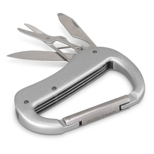 A silver carabiner multi-tool featuring scissors, a knife, and a flathead screwdriver. It has a logo on the handle.